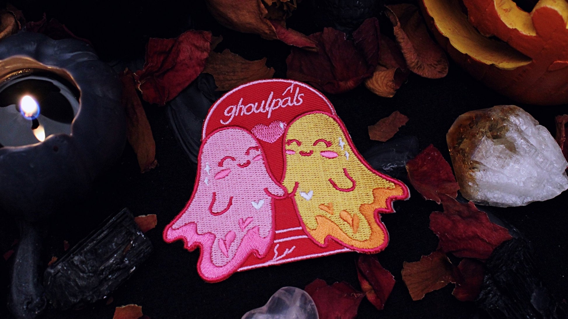 Ghoulpals Lesbian Patch - Iron on  embroidered patch of two cute and smiling ghosts holding hands in front a tombstone that says "ghoulpals" with a heart in between them, in the colours of the lesbian flag which is orange, pink, and magenta. Original design by GRRRL Spells. 