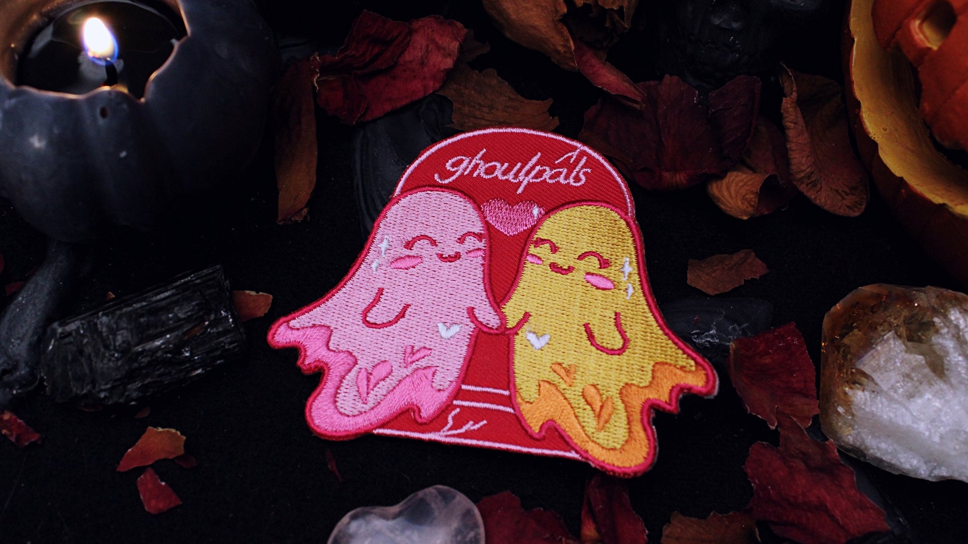 Ghoulpals Lesbian Patch - Iron on  embroidered patch of two cute and smiling ghosts holding hands in front a tombstone that says "ghoulpals" with a heart in between them, in the colours of the lesbian flag which is orange, pink, and magenta. Original design by GRRRL Spells. 