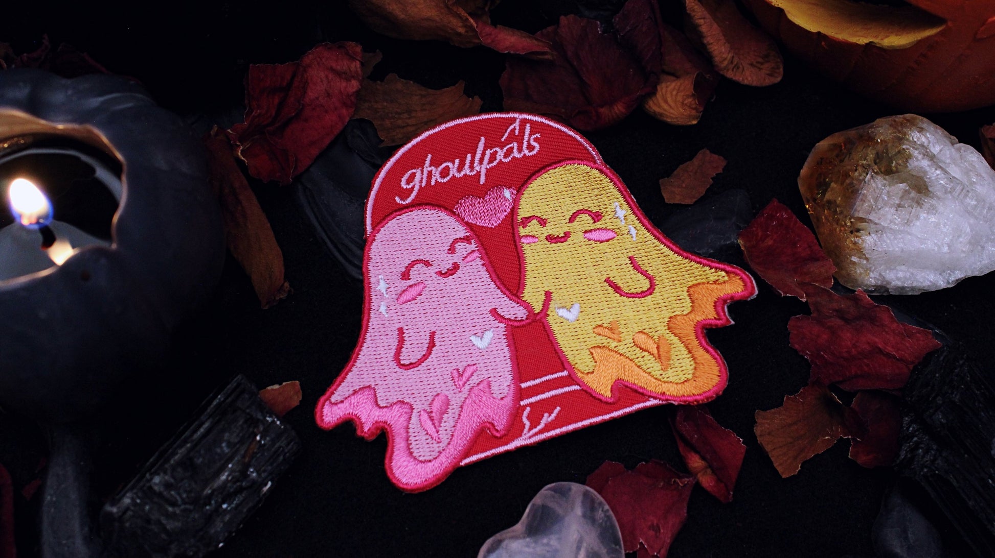 Ghoulpals Lesbian Patch - Iron on  embroidered patch of two cute and smiling ghosts holding hands in front a tombstone that says "ghoulpals" with a heart in between them, in the colours of the lesbian flag which is orange, pink, and magenta. Original design by GRRRL Spells. 