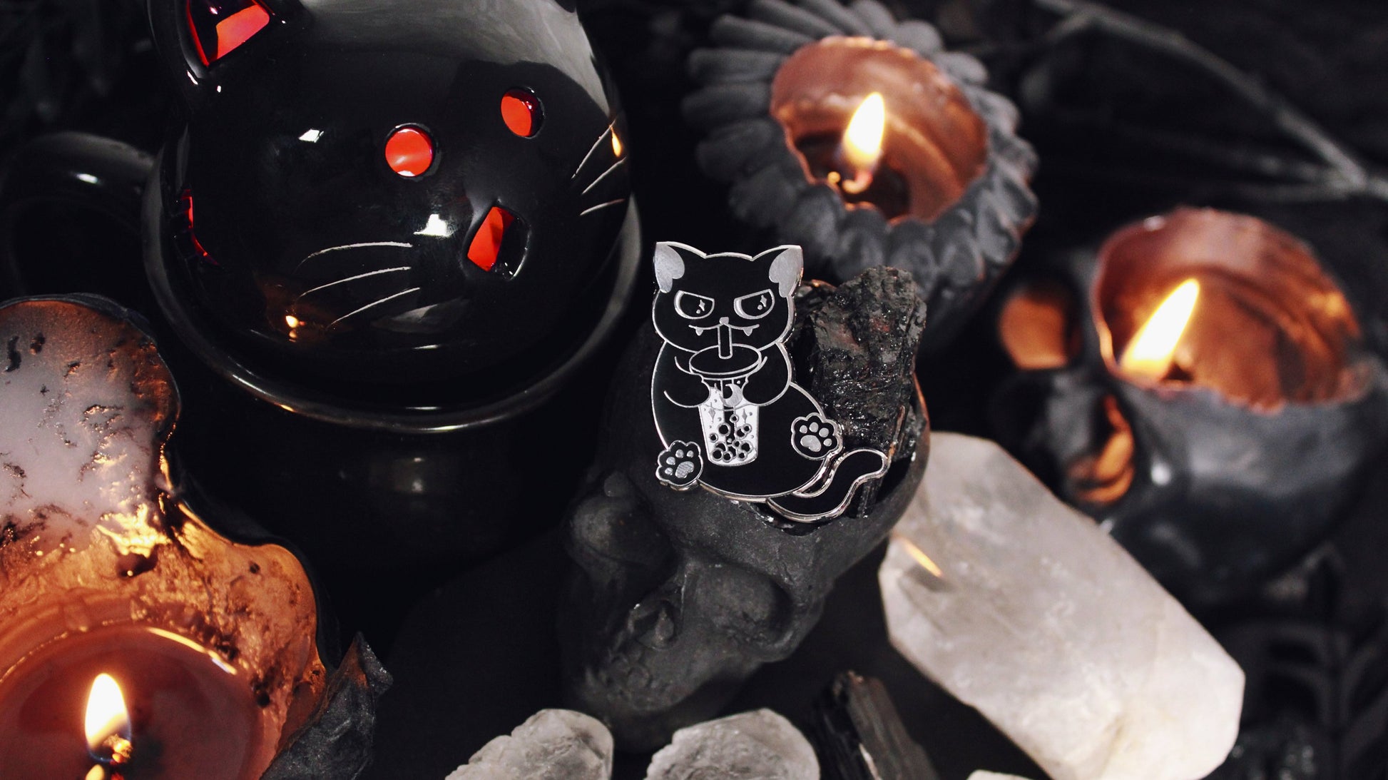 Black Cat Boba Pin - Silver plated enamel pin of a cute black cat sitting upright with a little smirk on its face while sipping on a cup of bubble tea/boba with moon and stars in it. Original design by GRRRL Spells.